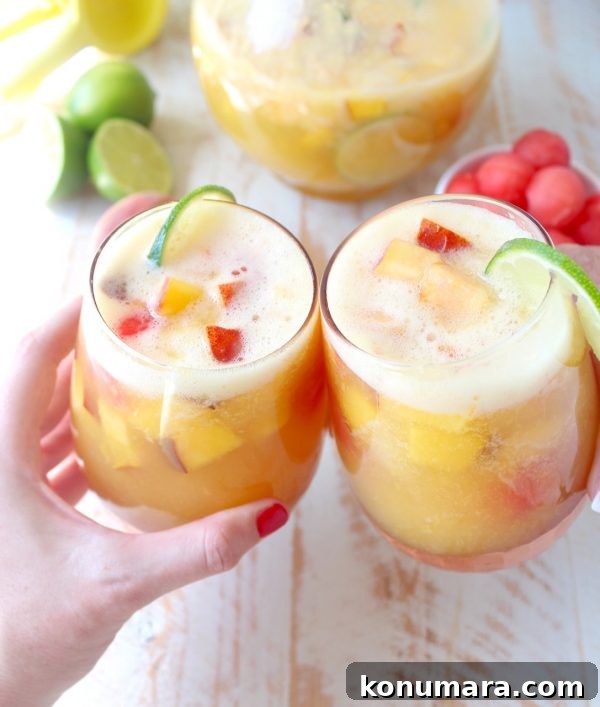 This white peach sangria is the perfect summer cocktail recipe combining refreshing white wine with fresh peaches, nectarines and lime juice!
