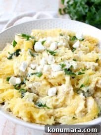 Baked spaghetti squash with spinach artichoke sauce