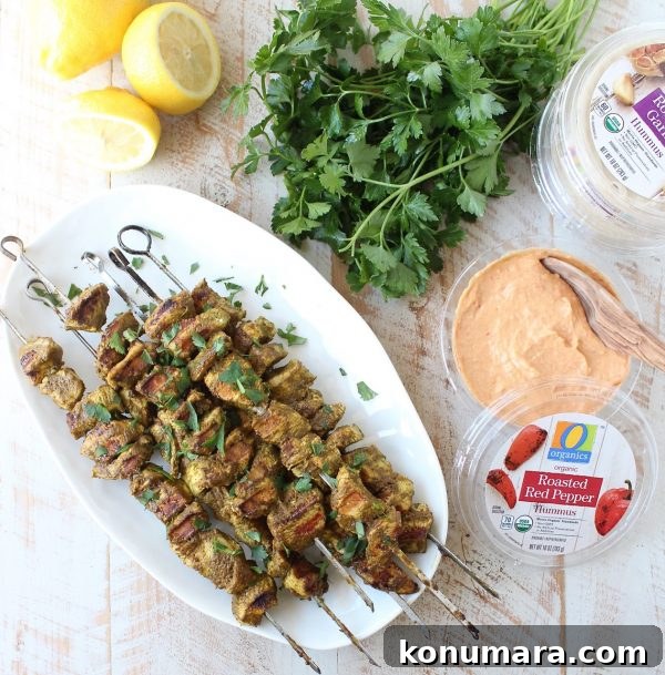 Grilled Mediterranean Chicken Skewers with Lemon and Herbs 5 Plated Mediterranean Chicken Skewers served with hummus and fresh greens