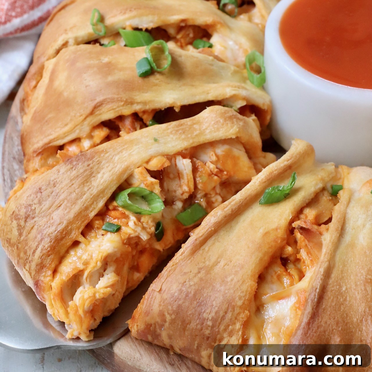 buffalo chicken taco ring on serving platter with diced green onions on top