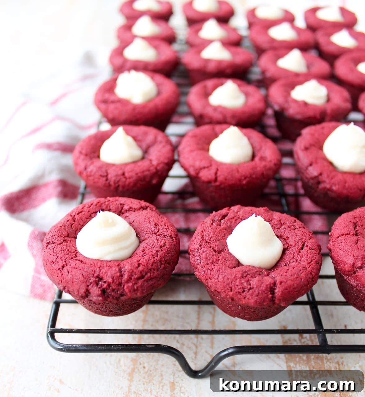 Red velvet cookie cups filled with cream cheese frosting are a delicious and adorable dessert recipe that's also easy to make! Perfect for Valentine's Day, birthdays or any day you're craving a sweet treat!