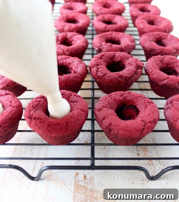 Red velvet cookie cups filled with cream cheese frosting are a delicious and adorable dessert recipe that's also easy to make! Perfect for Valentine's Day, birthdays or any day you're craving a sweet treat!