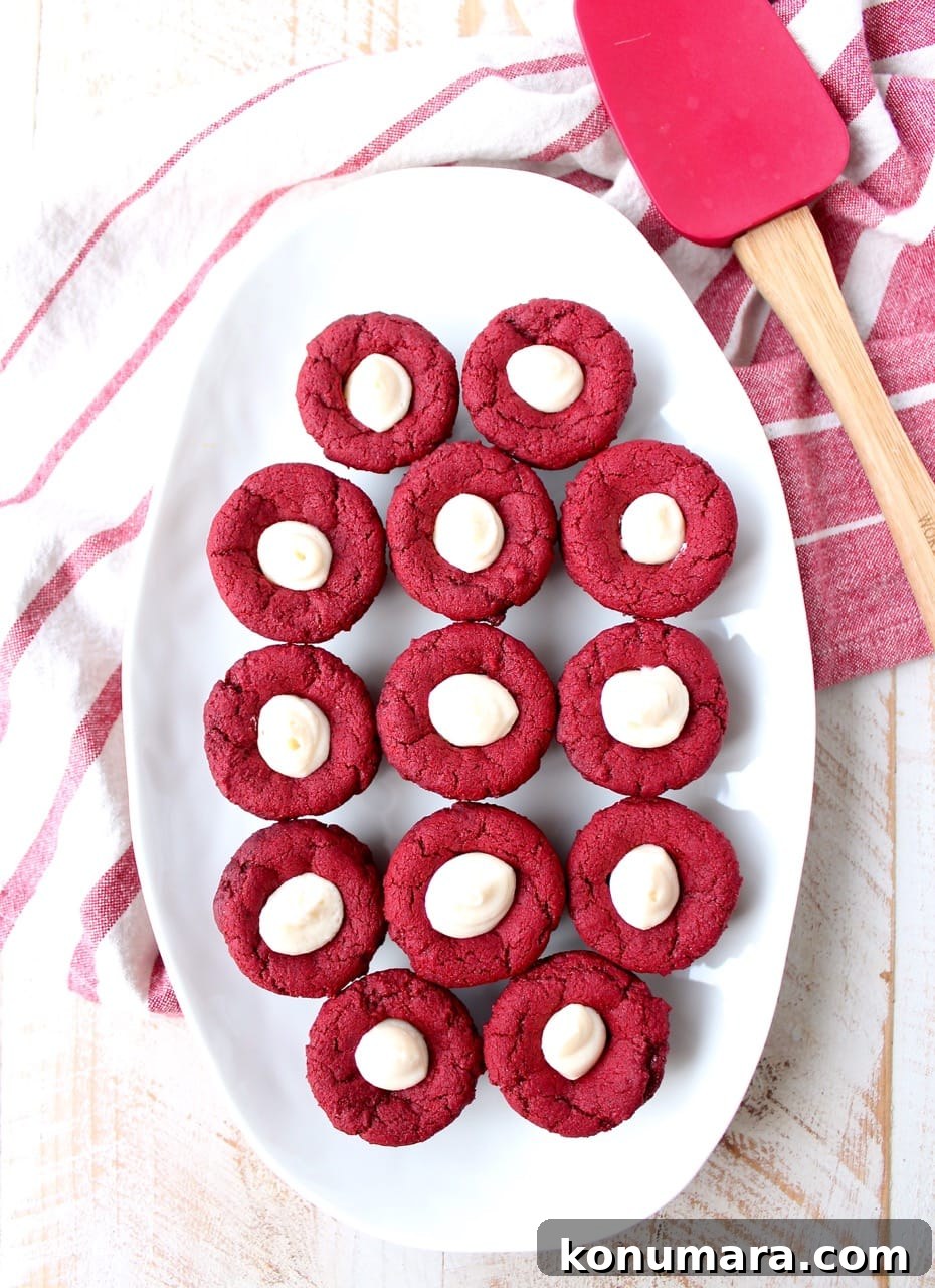 Red velvet cookie cups filled with cream cheese frosting are a delicious and adorable dessert recipe that's also easy to make! Perfect for Valentine's Day, birthdays or any day you're craving a sweet treat!
