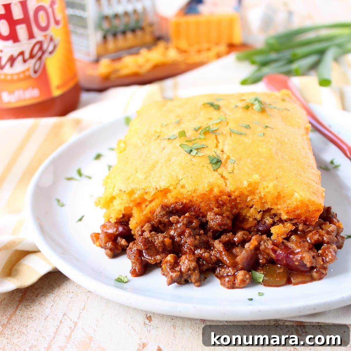 piece of cornbread chili pie on white plate with fork