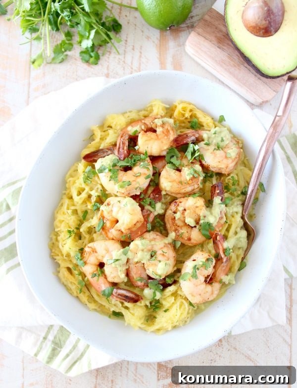 Close-up of cilantro lime shrimp served over spaghetti squash with avocado sauce