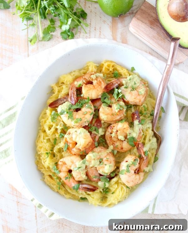 Served plate of spaghetti squash with shrimp and avocado sauce