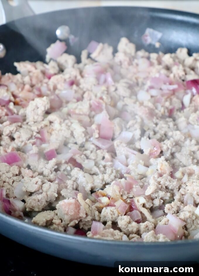 Smoky Chipotle Chili Stuffed Sweet Potatoes Recipe 5 cooked ground turkey in skillet with onions and garlic