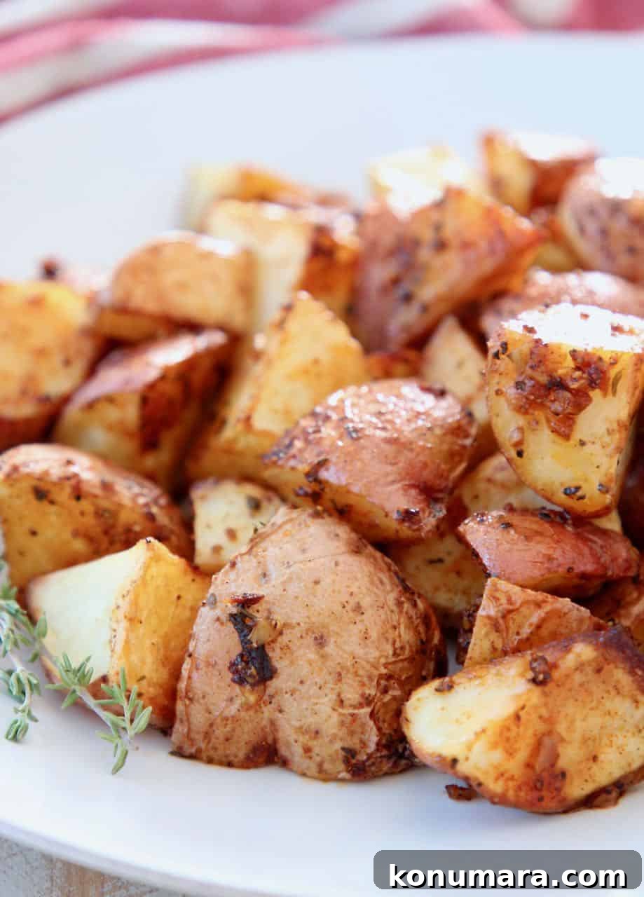 Crispy Cajun Roasted Potatoes Recipe 4 Oven roasted cubed Cajun potatoes on white plate