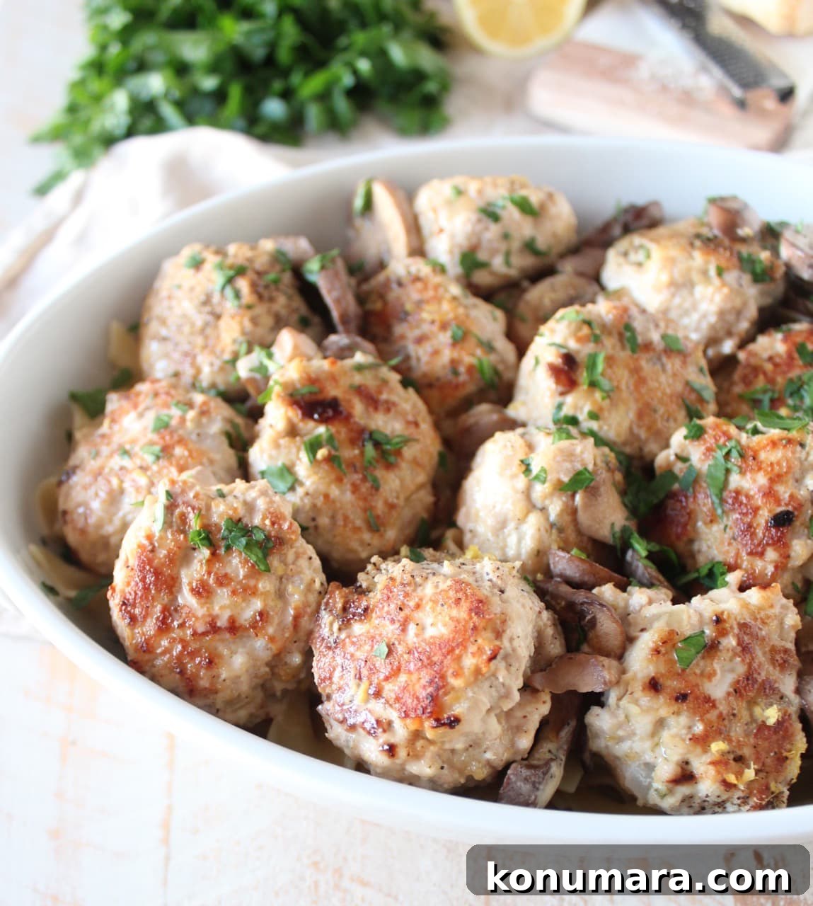 cooked meatballs with mushrooms in a casserole dish