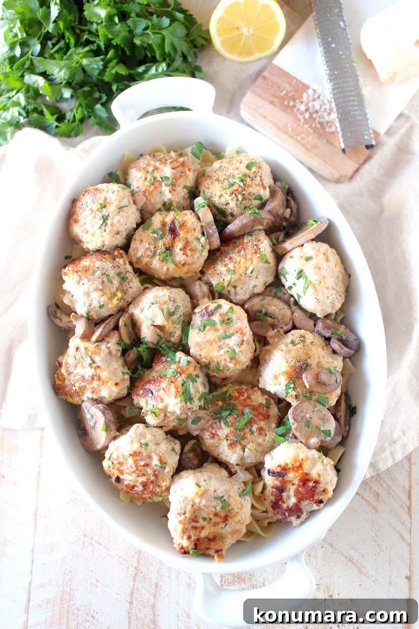 cooked meatballs in a casserole dish with a mushroom sauce and noodles
