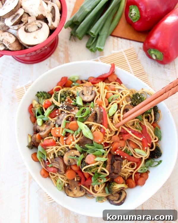 Lo mein noodles and fresh veggies are tossed with a homemade General Tso sauce in this easy Vegetarian General Tso Stir Fry recipe, made in just 25 minutes! General Tso Noodles with Chopsticks