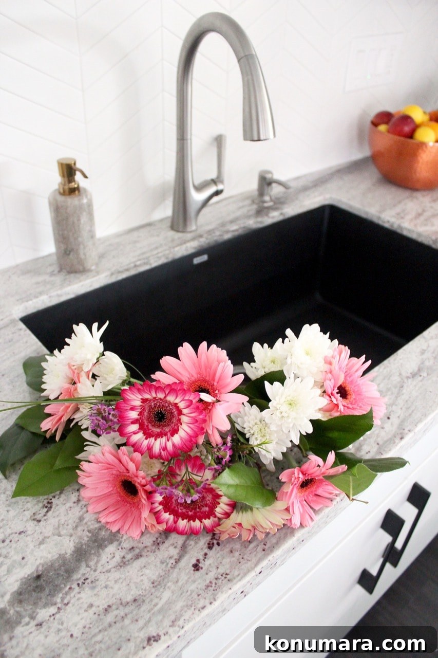 Large kitchen sink with pink and white flowers in the sink