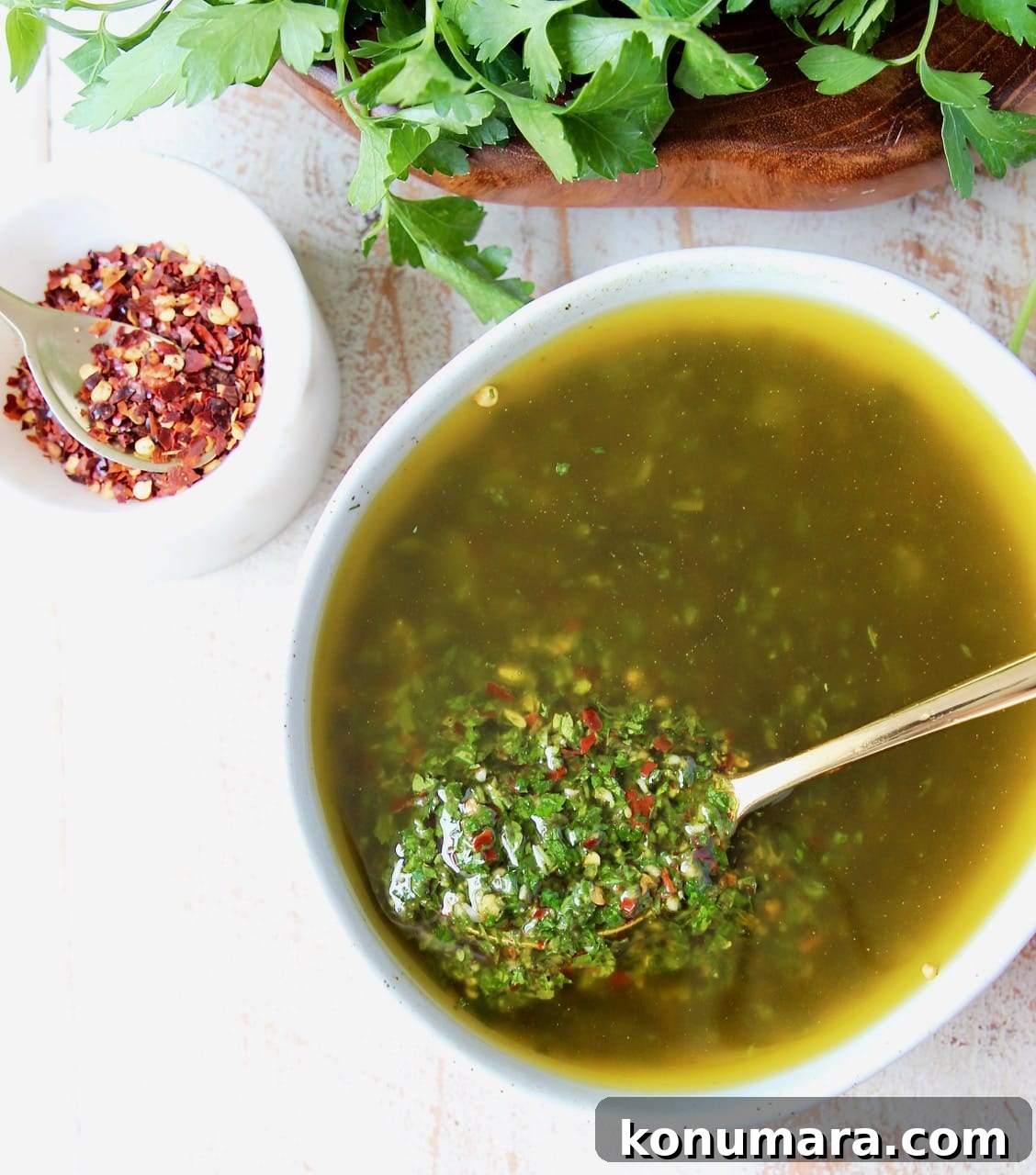 Authentic Chimichurri Sauce Recipe for Grilled Meats 3 chimichurri sauce in a bowl with a gold spoon