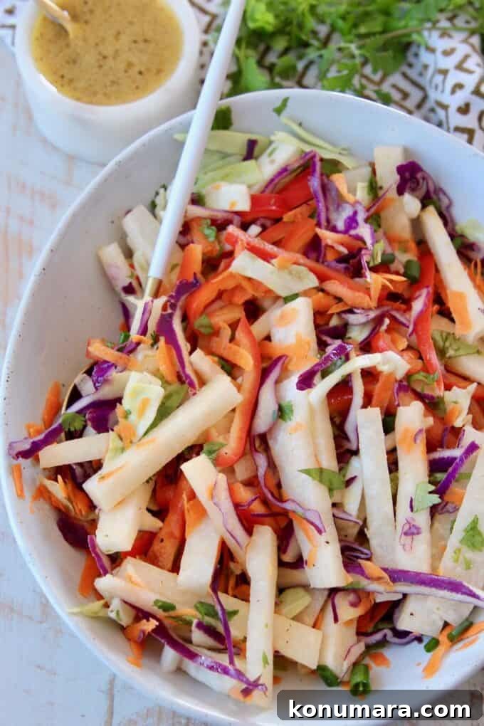 Crisp Jicama Slaw with Lime and Cilantro 4 jicama coleslaw in bowl with spoon