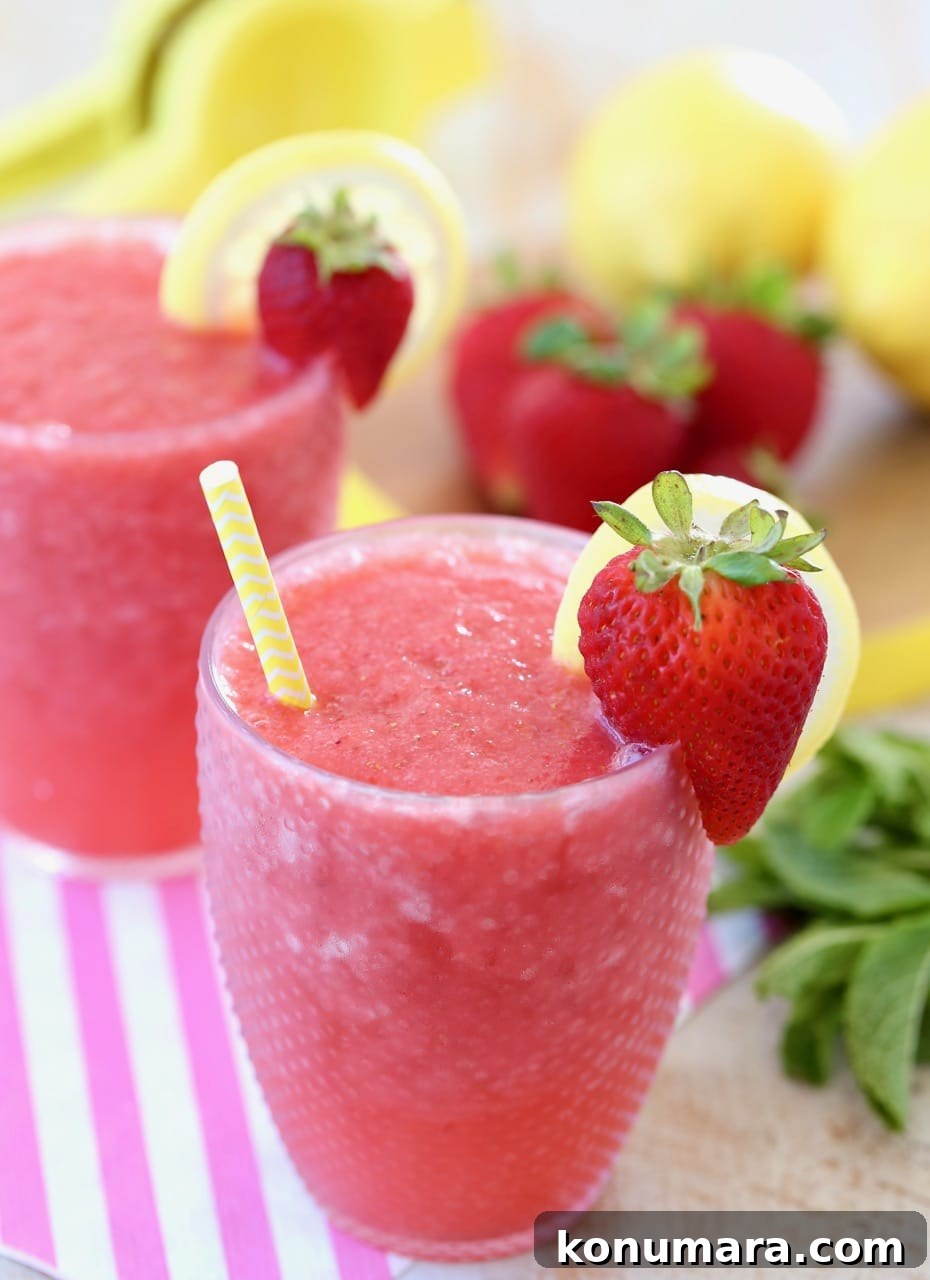 Lemon Berry White Wine Slushies with Yellow Straw and Fresh Strawberries