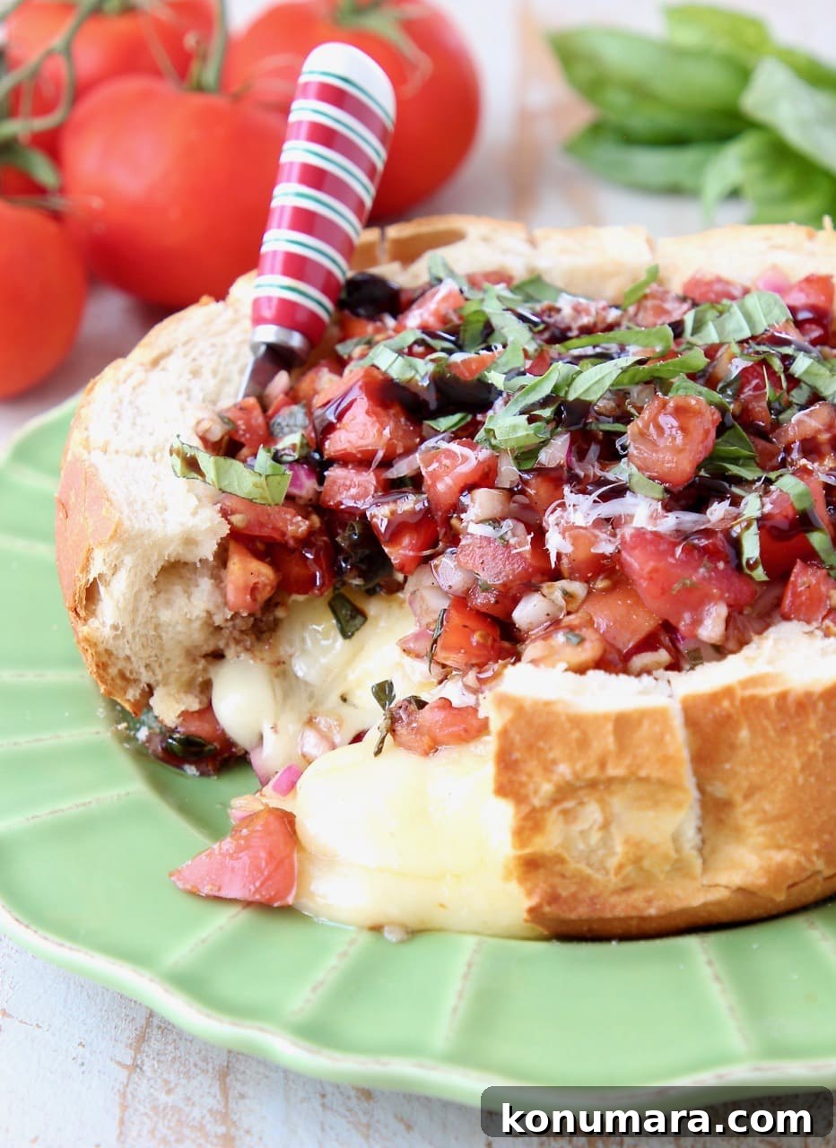 Baked Brie in a Sourdough Bread Bowl topped with Tomato Basil Bruschetta