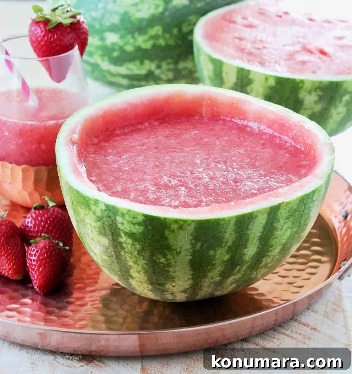 Strawberry Watermelon Wine Slushies Recipe 3 Strawberry Watermelon White Wine Slushies served in a hollowed watermelon on a copper tray