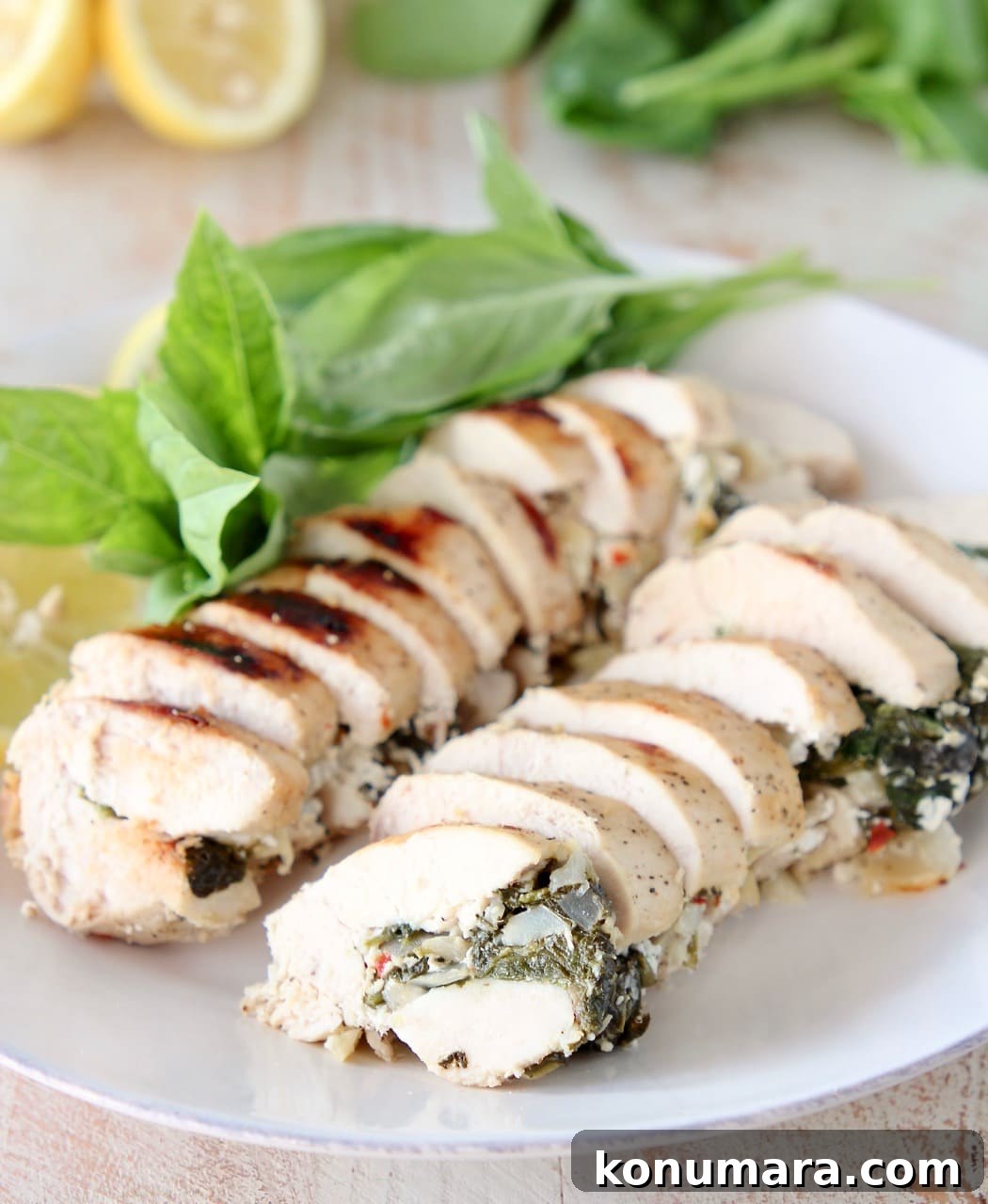 Sliced Spinach Artichoke Chicken with Fresh Basil and Lemons