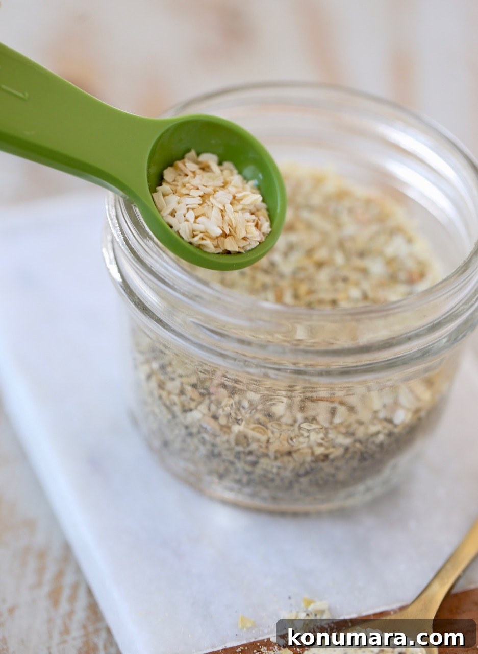 Homemade French Onion Dip Mix Recipe 4 French Onion Dip Mix in Mason Jar with Minced Onions in Green Measuring Spoon