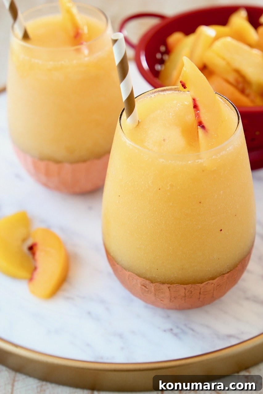 Frozen Peach Sangria Recipe - Refreshing Summer Cocktail 2 Frozen Peach Sangria on Copper Tray with Fresh Peaches