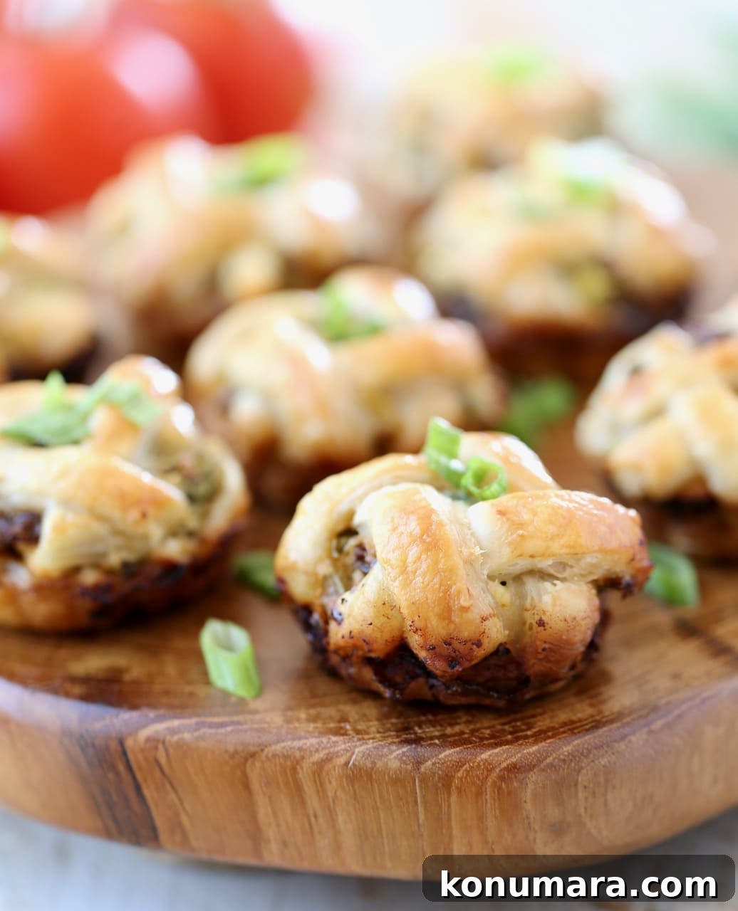 Mini Spinach and Feta Pies 5 Spinach Feta Mini Pies with Braided Puff Pastry Crust on Wood Serving Board