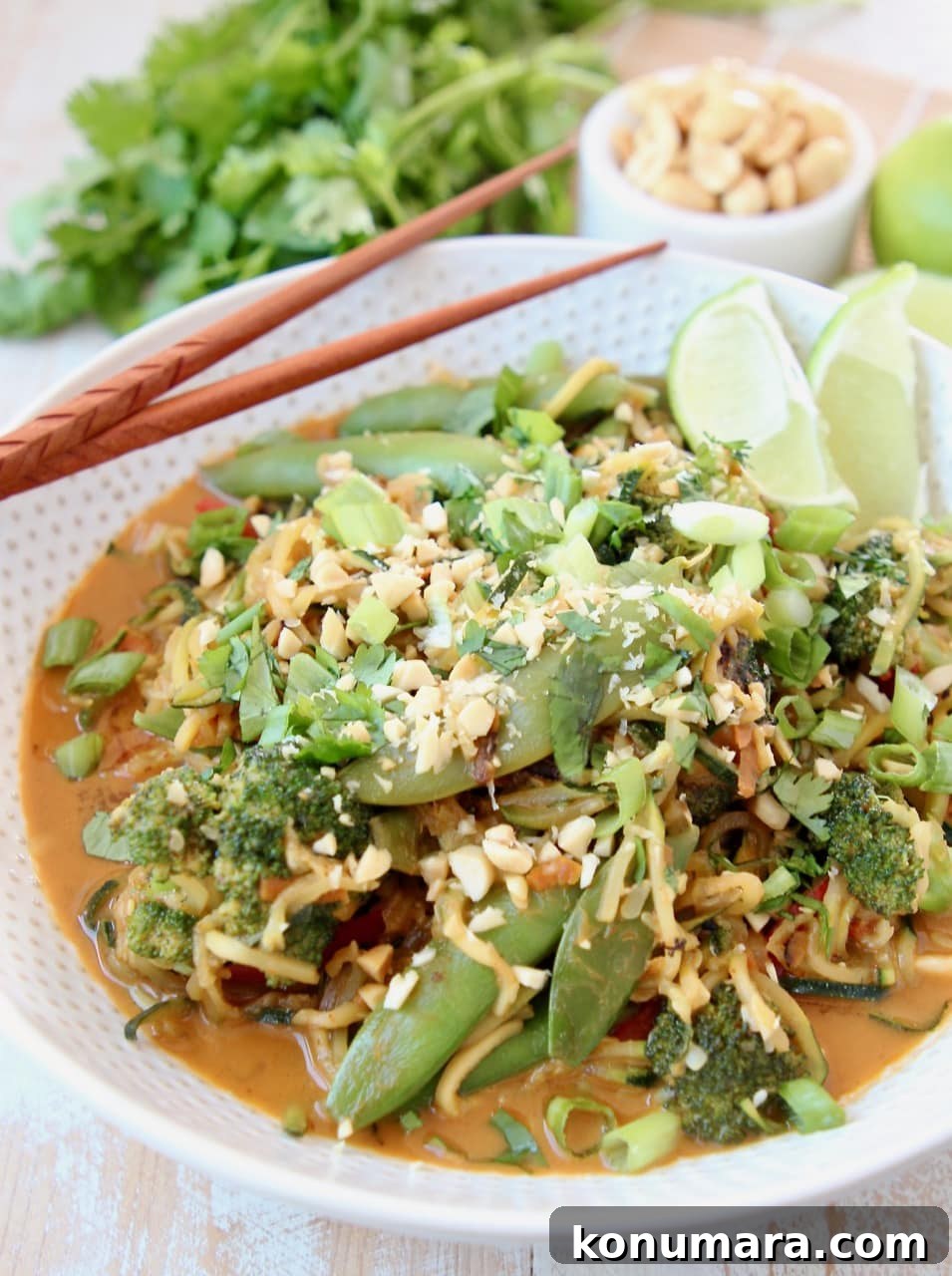 Vegan Zucchini Noodle Pad Thai with Peanut Sauce 3 Vegan Pad Thai with Zucchini Noodles, Broccoli, Sugar Snap Peas, Carrots, Pad Thai Peanut Sauce, Scallions and Limes in a bowl