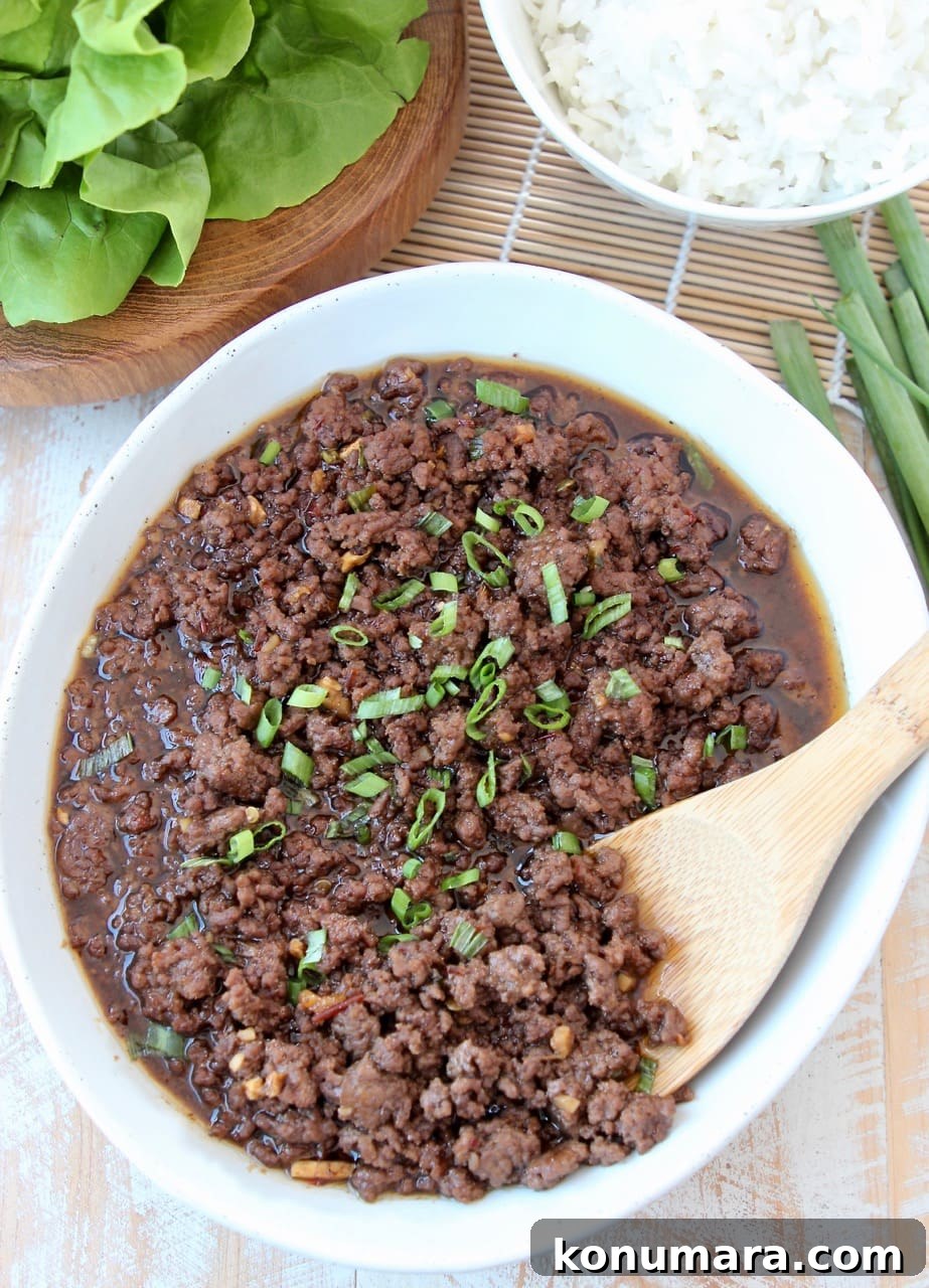 Korean BBQ Beef (Bulgogi) Recipe: Sweet and Savory Marinade 3 Korean BBQ Beef Recipe in Large Bowl with Wooden Spoon and Bowl of Rice