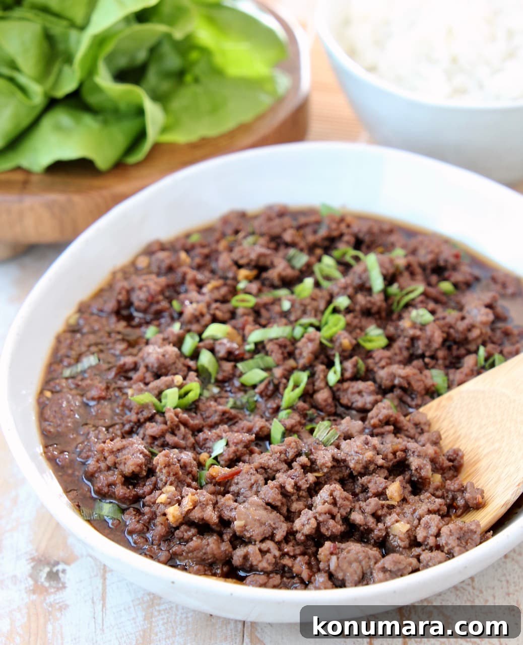 Korean BBQ Beef (Bulgogi) Recipe: Sweet and Savory Marinade 4 Korean BBQ Ground Beef in Bowl with Scallions and Wooden Spoon