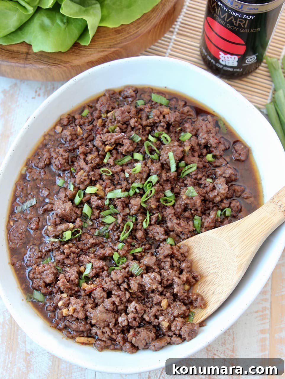 Korean BBQ Beef (Bulgogi) Recipe: Sweet and Savory Marinade 8 Korean BBQ Beef with Diced Scallions in Bowl with Wood Spoon