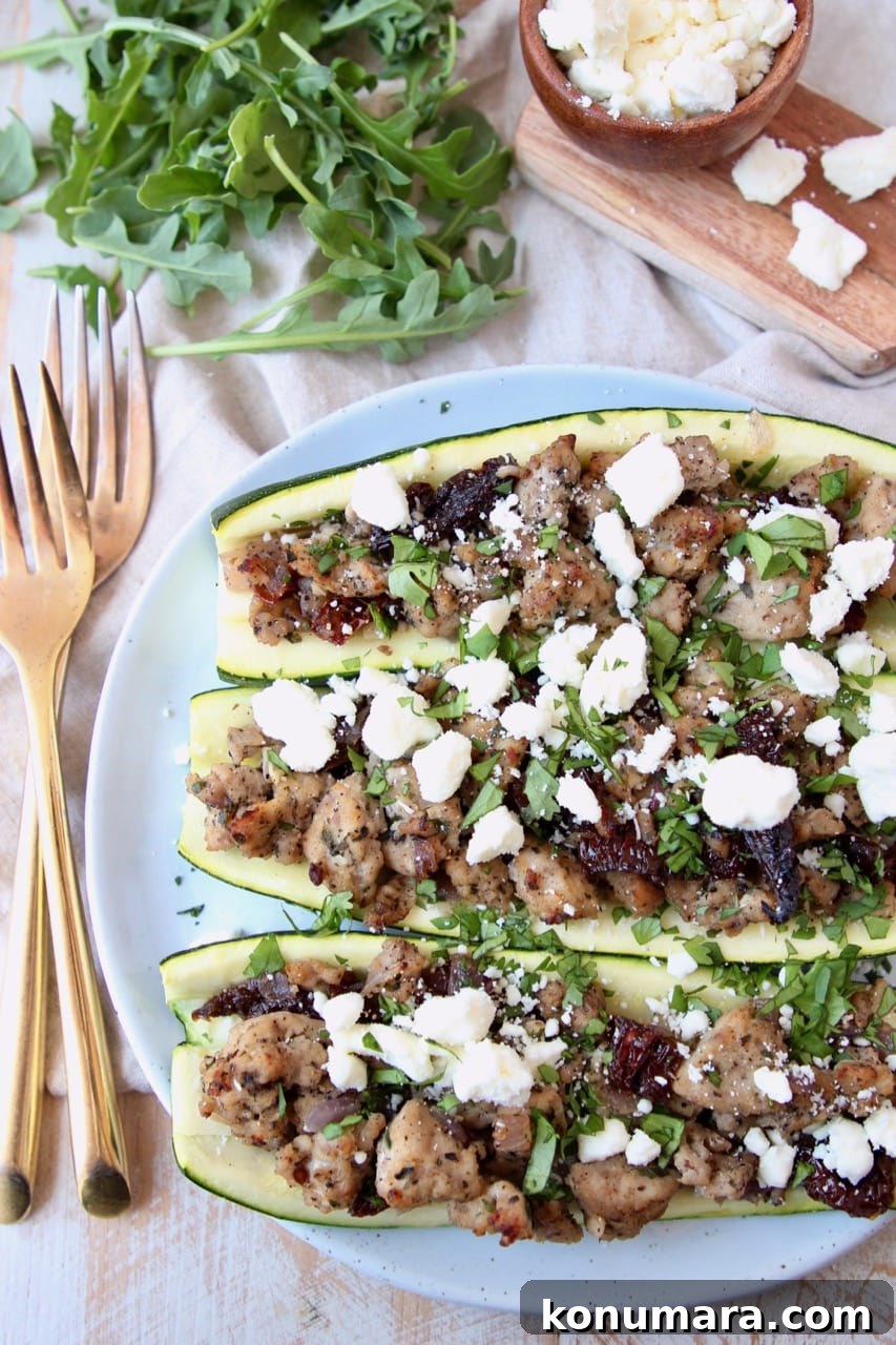 Greek Turkey-Stuffed Zucchini Boats with Feta 3 Overhead shot of cooked ground turkey stuffed in zucchini halves topped with crumbled feta cheese