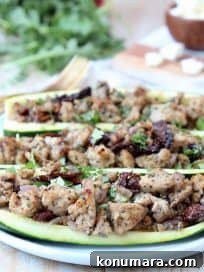 Greek Turkey-Stuffed Zucchini Boats with Feta 6 Greek Turkey Stuffed Zucchini Boats on Plate