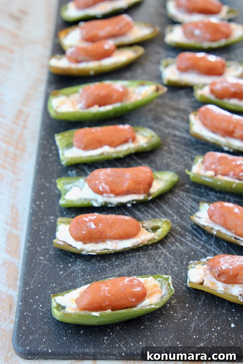 little smokies in a jalapeno popper on a cutting board