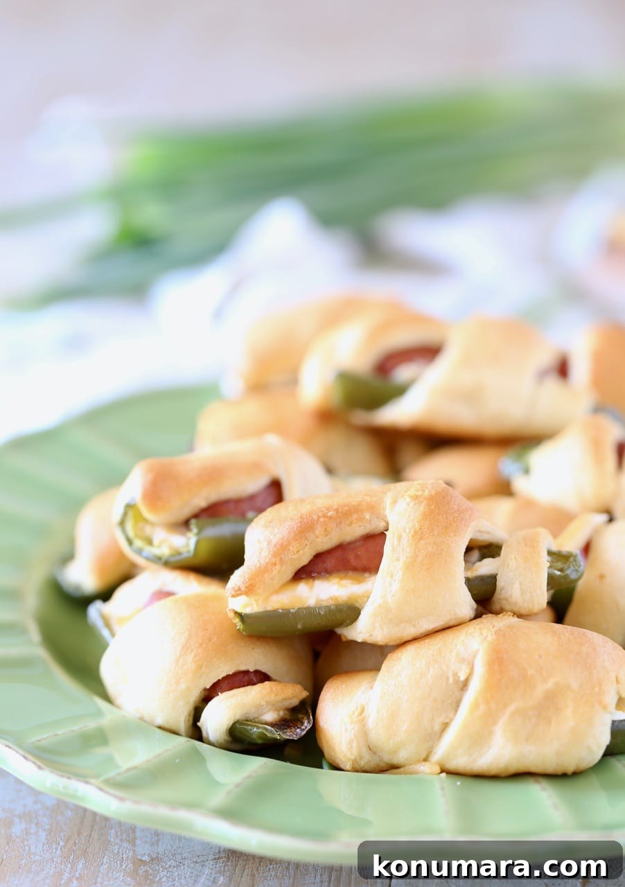 Jalapeno Poppers with Little Smokies Wrapped in Crescent Roll Dough on a plate