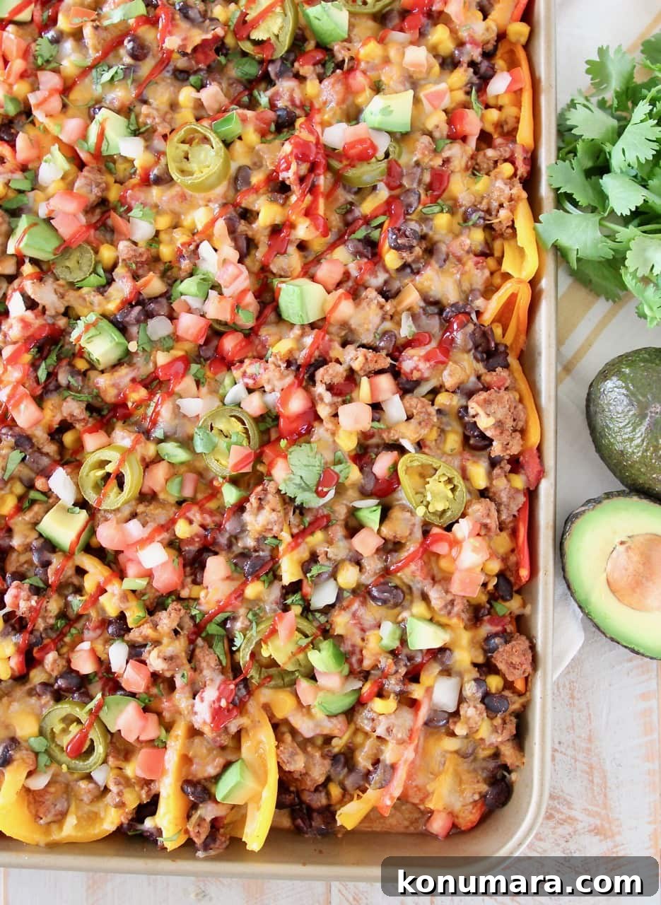 nachos made with sweet mini peppers, covered in taco seasoned ground turkey, corn, tomatoes, black beans, cheese and jalapenos