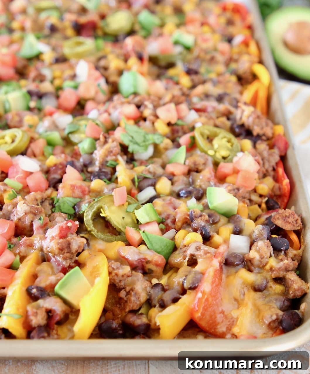 Low Carb Nachos made with sweet mini peppers topped with turkey, beans, corn, tomatoes, jalapenos and cheese