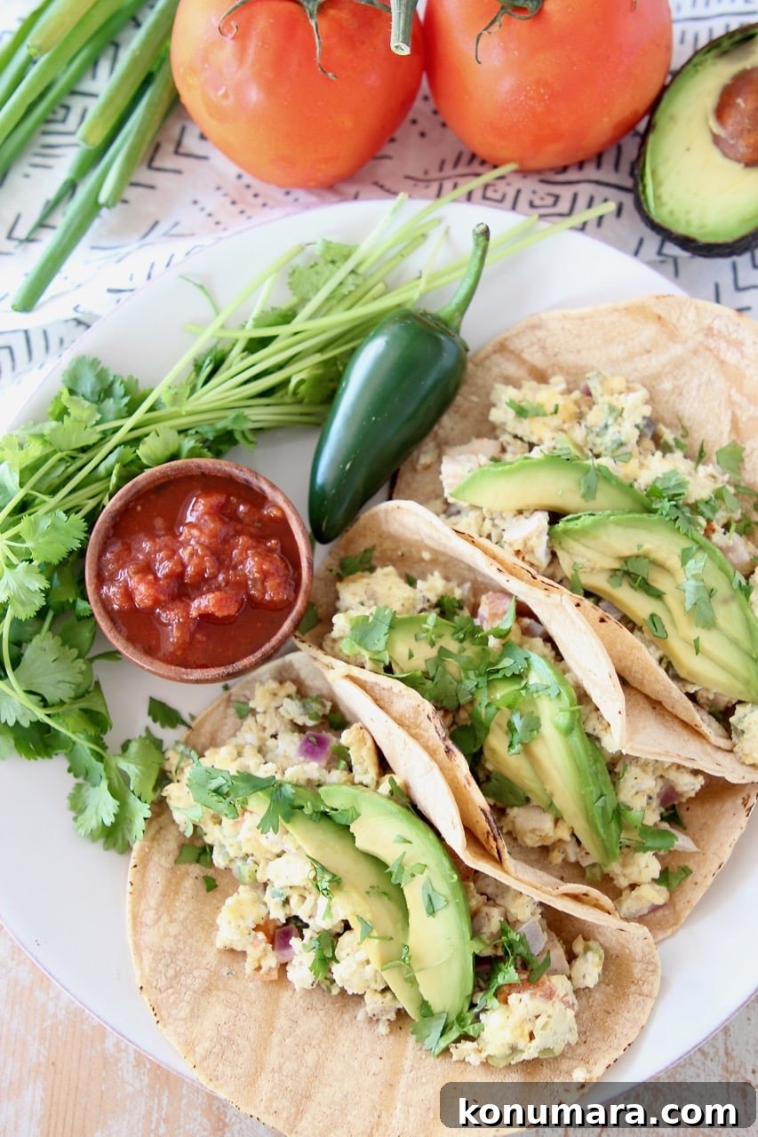 Pressure Cooker Breakfast Tacos Recipe 2 Egg, veggie, cheese breakfast tacos with sliced avocado, jalapeno and small cup of salsa
