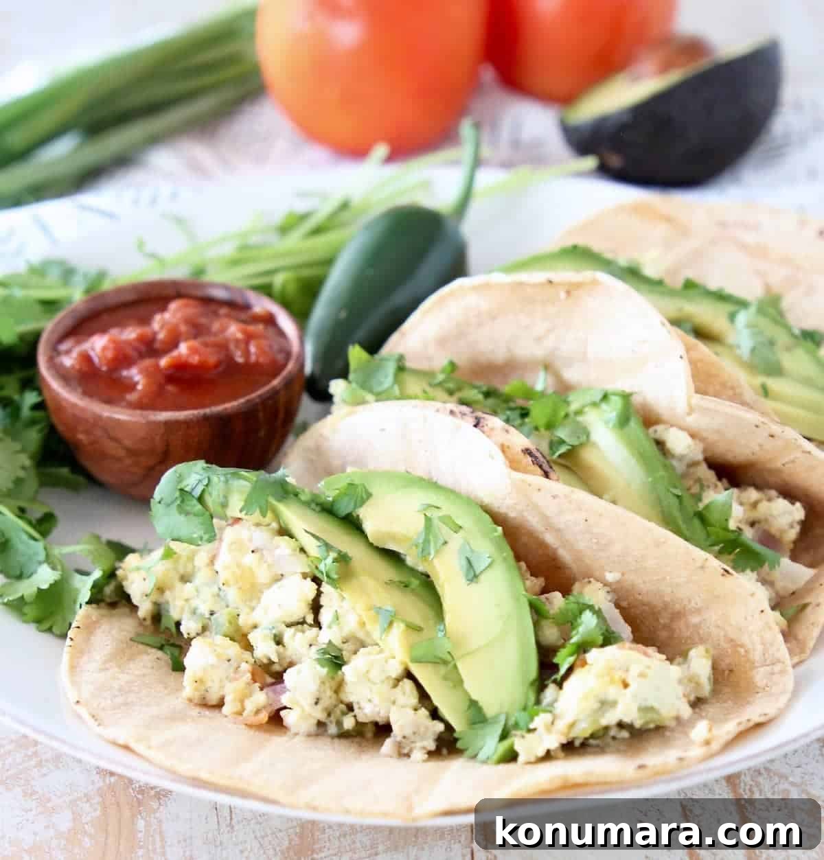 Pressure Cooker Breakfast Tacos Recipe 5 Breakfast egg tacos on corn tortillas with sliced avocado and cilantro