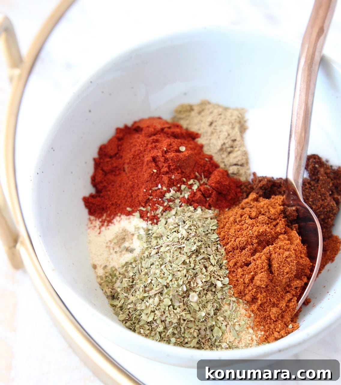 Homemade Taco Seasoning Mix Recipe 2 dried herbs and spices separated in bowl with spoon