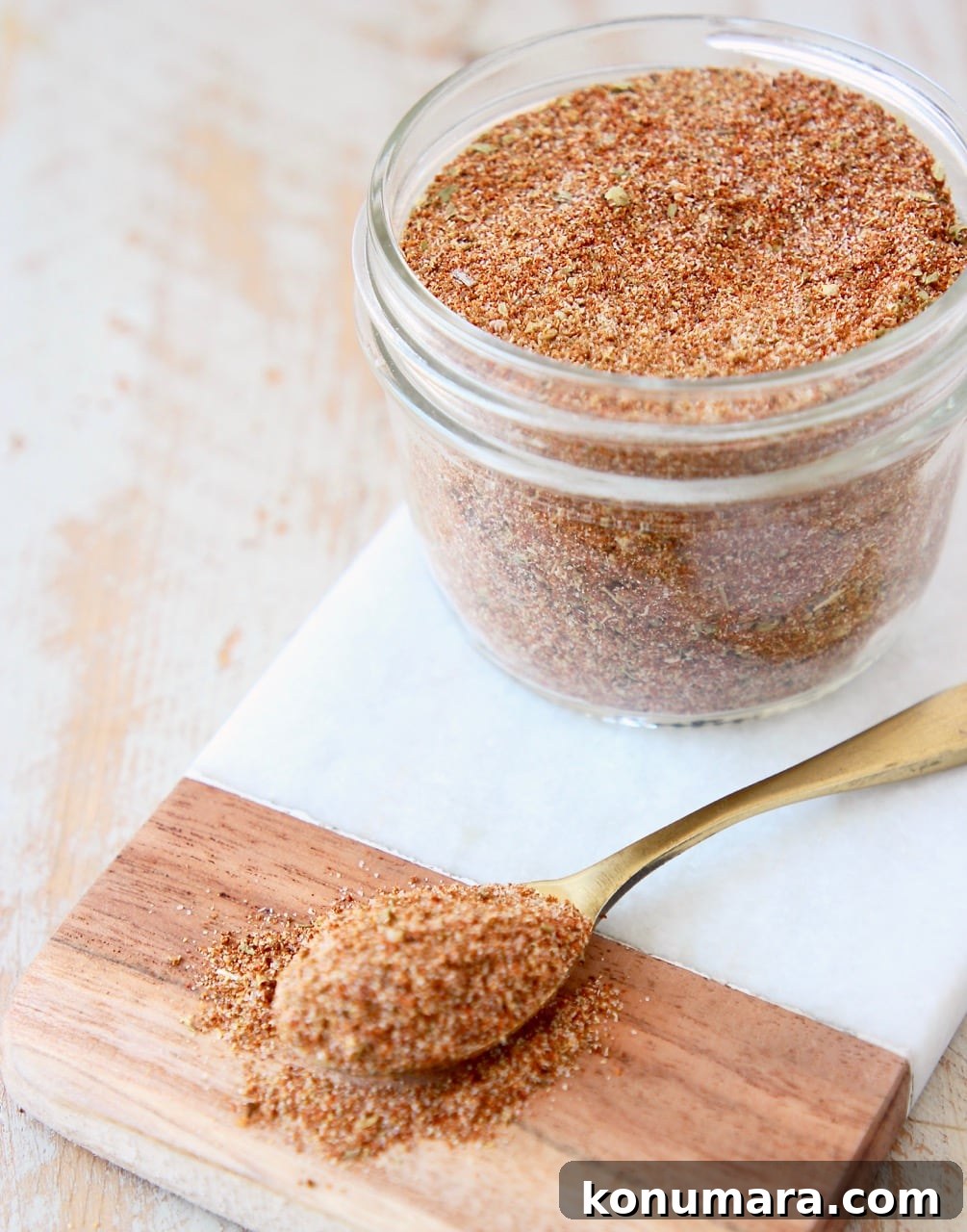 Homemade Taco Seasoning Mix Recipe 4 taco seasoning in mason jar on marble cutting board with spoon of taco seasoning