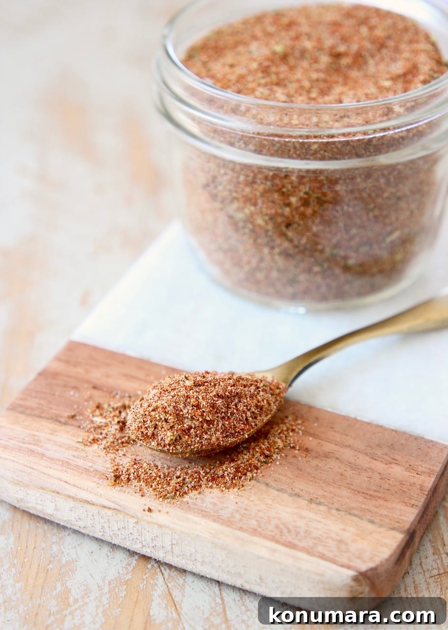 Homemade Taco Seasoning Mix Recipe 6 Homemade taco seasoning in mason jar on marble cutting board with spoon of taco seasoning