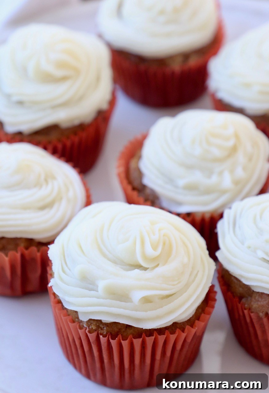 Moist Pumpkin Cupcakes with Tangy Cream Cheese Frosting 10 pumpkin cupcakes with cream cheese frosting on plate