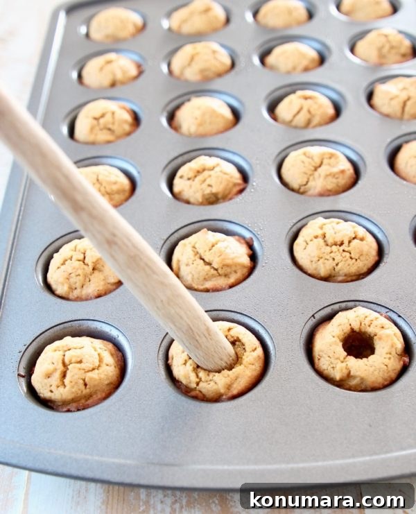 Salted Caramel Pumpkin Cookie Cups 5 Using the end of a spatula to make pumpkin cookie cups in mini muffin tin