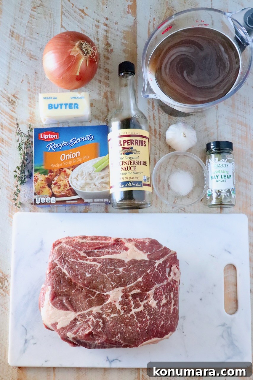 Savory French Onion Pot Roast with Caramelized Onions 3 Ingredients for a roast: raw beef, onion, butter, onion soup mix, Worcestershire sauce, garlic, broth, salt, bay leaves, and thyme on a wooden surface.