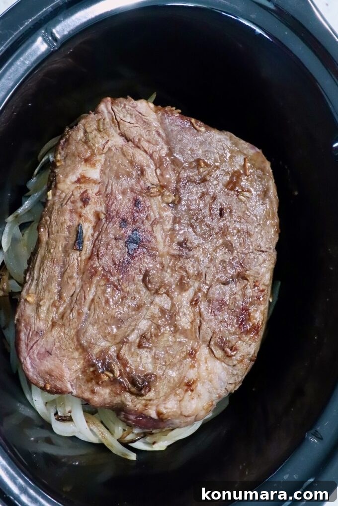 Savory French Onion Pot Roast with Caramelized Onions 9 seasoned, seared beef roast in a crock pot