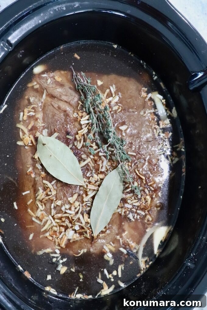 Savory French Onion Pot Roast with Caramelized Onions 10 seasoned, seared beef roast in a crock pot with beef stock, bay leaves and thyme sprigs