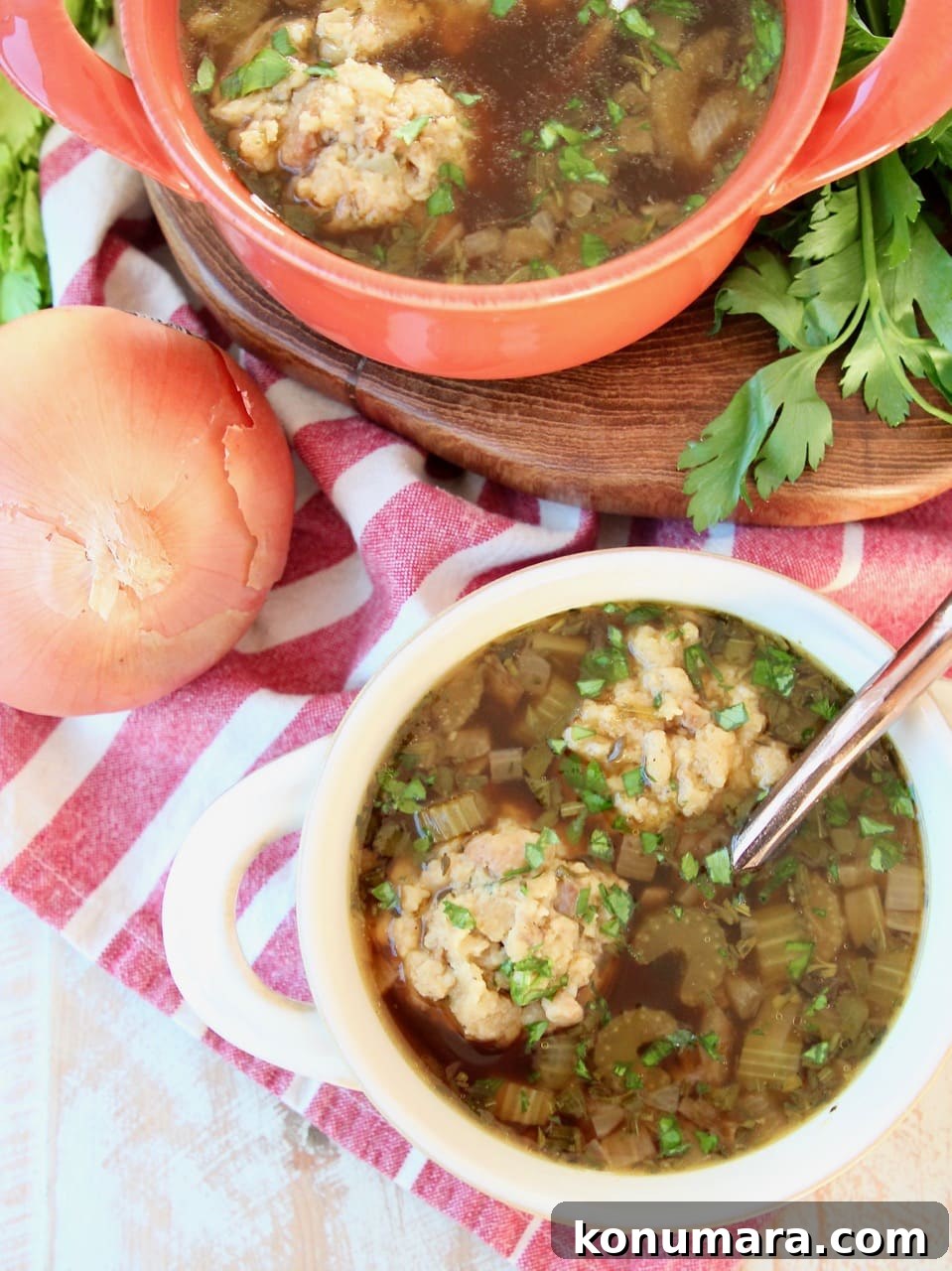 Instant Pot Turkey Soup with Savory Stuffing Dumplings 3 Overhead shot of turkey soup with stuffing dumplings in soup crocks with copper spoons, sitting on a white and red towel with celery and yellow onion