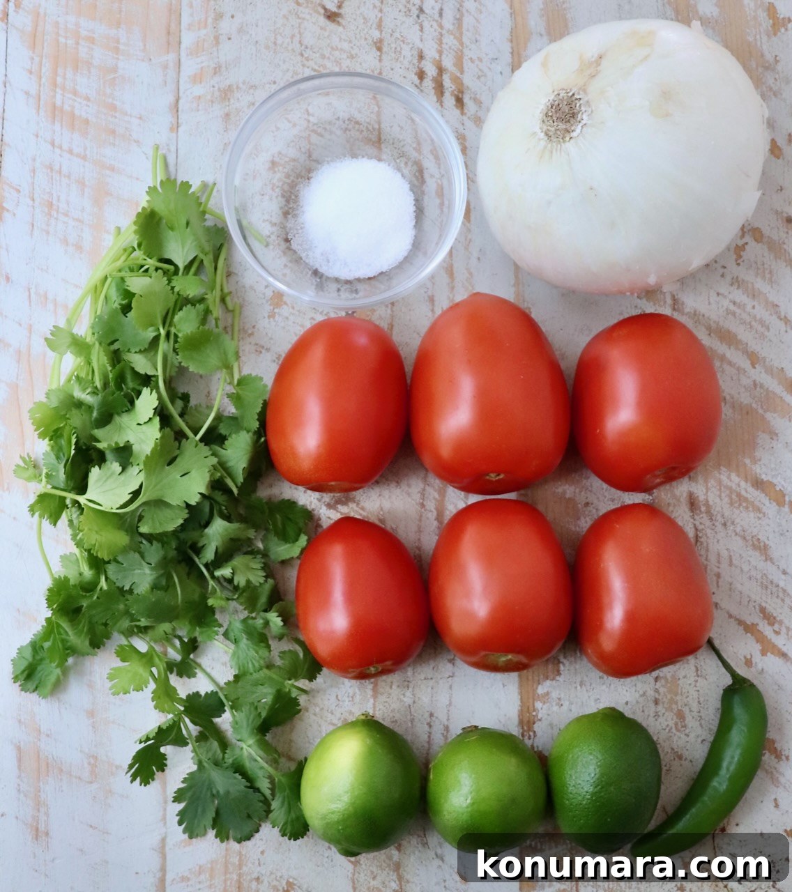 ingredients for pico de gallo on a white wood board