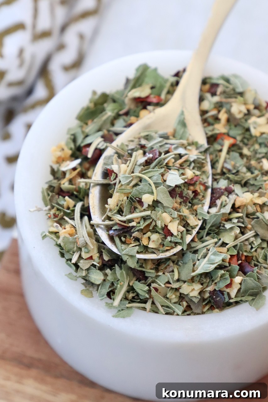 Homemade Italian Seasoning Mix for Pasta and Pizza 4 dried herbs and spices mixed together in a bowl with a spoon