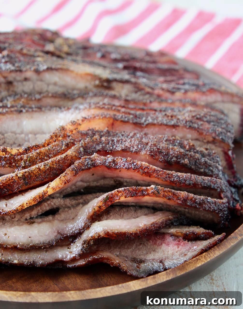 Sliced smoked brisket on wood tray