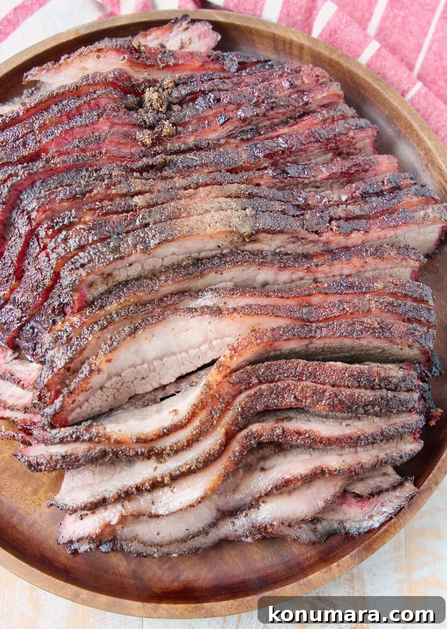 Overhead shot of sliced brisket on round wood serving tray